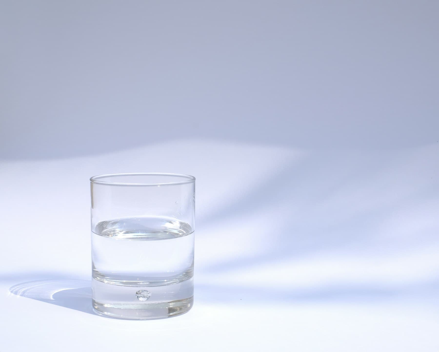 A clear drinking glass filled with water
